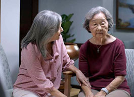 Photo of two elderly women sitting together. 